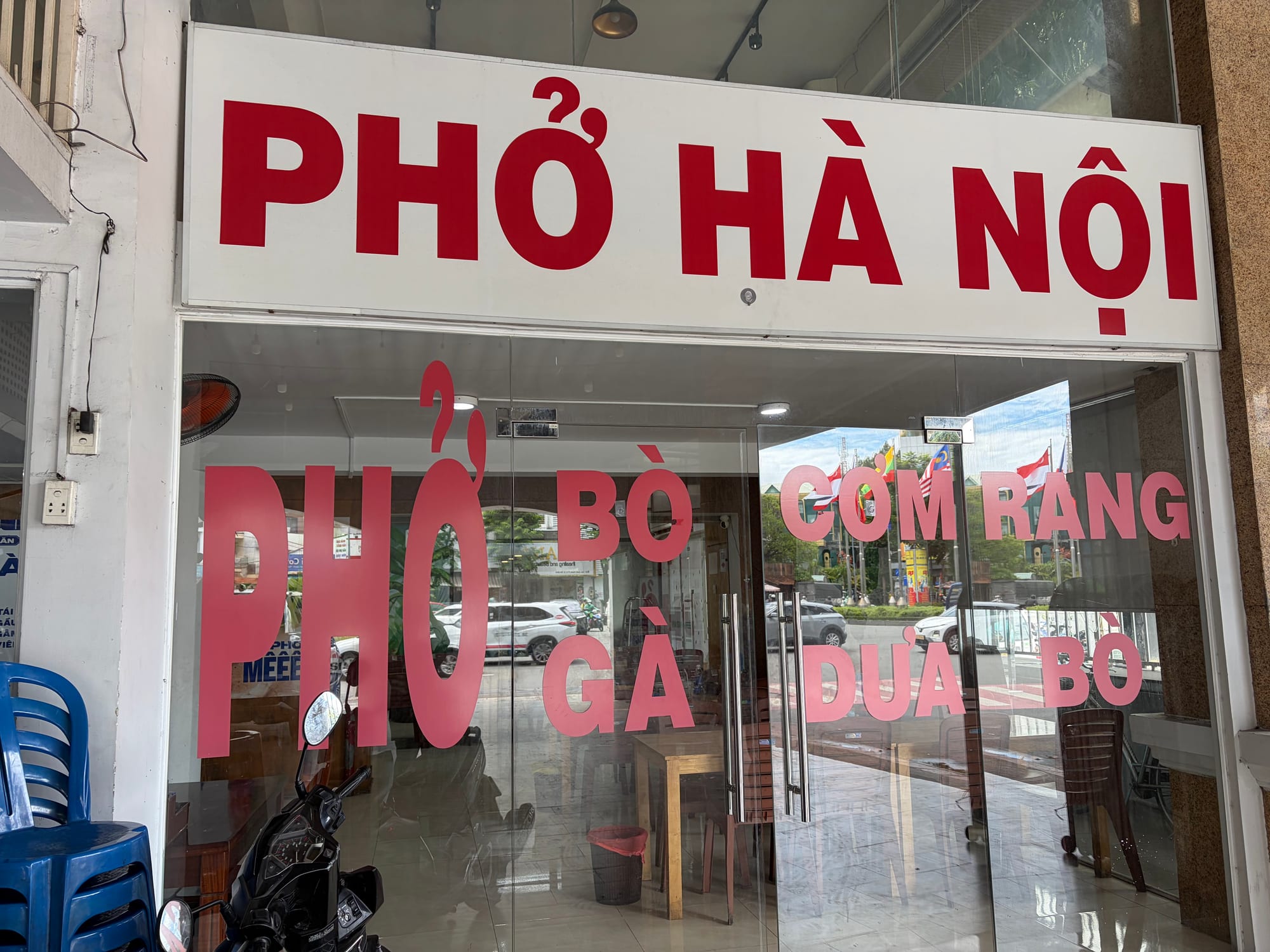 The Phở Phố restaurant storefront with signage visible through white display windows